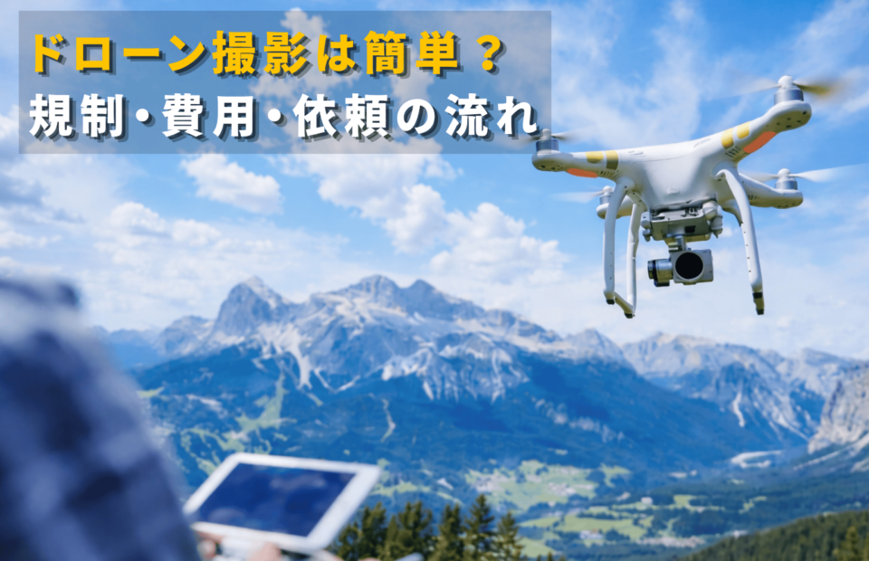 ドローン撮影の規制・費用・依頼の流れを解説するイメージ画像（空撮ドローンと山の風景）